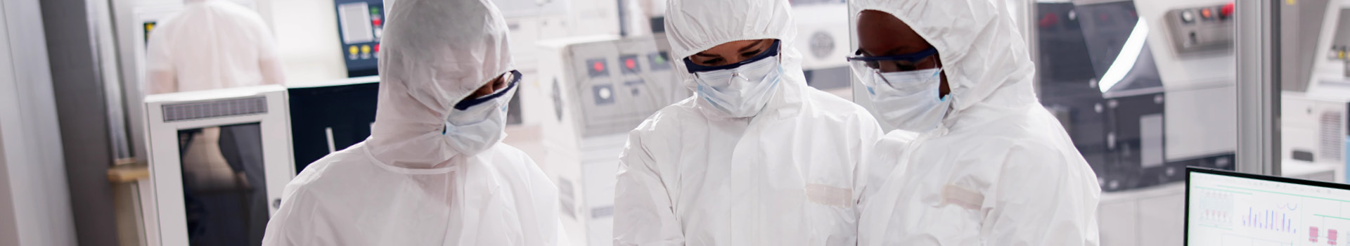 Semiconductor manufacturing cleanroom with staff in protective clothing