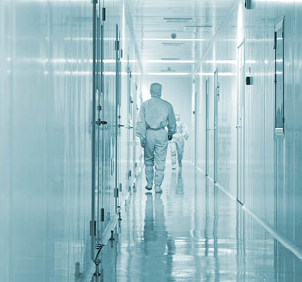 Engineers in particle-free cleanroom environment