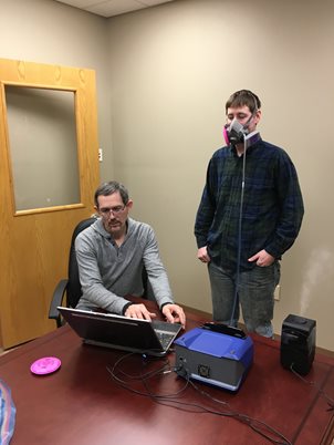 Nurse Practitioner Alec Rimmasch preparing to use the PortaCount Respirator Fit Tester