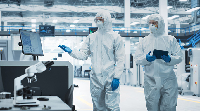 cleanroom environment with advanced monitoring systems, showcasing particle counters, pressure sensors, and environmental controls, emphasizing ISO 14644-1 compliance in precision manufacturing