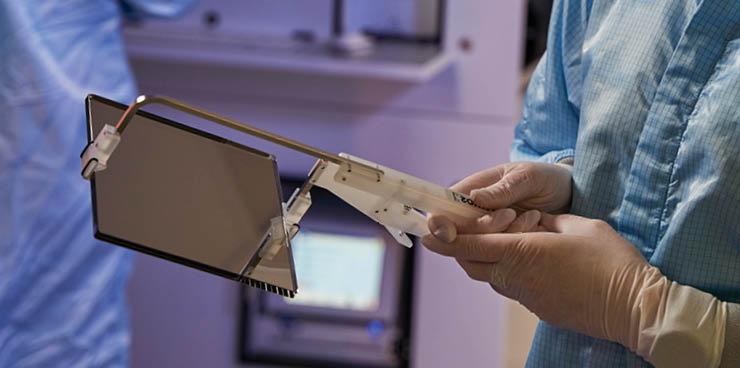 Silicon wafer in a clean processing room being hold by an engineer